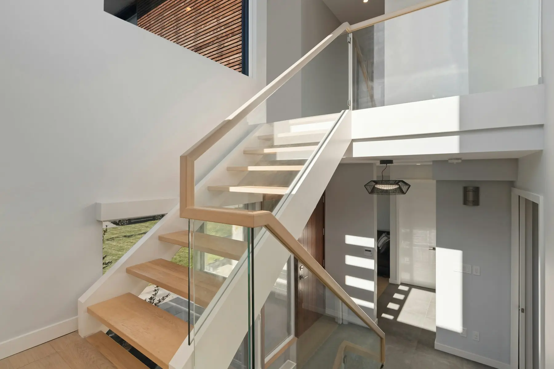 Modern staircase with oak treads and glass railing