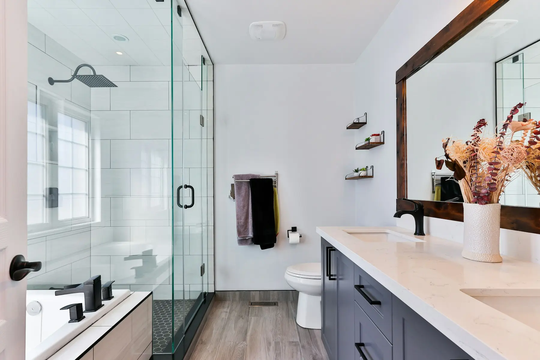 Frameless glass shower with black fixtures