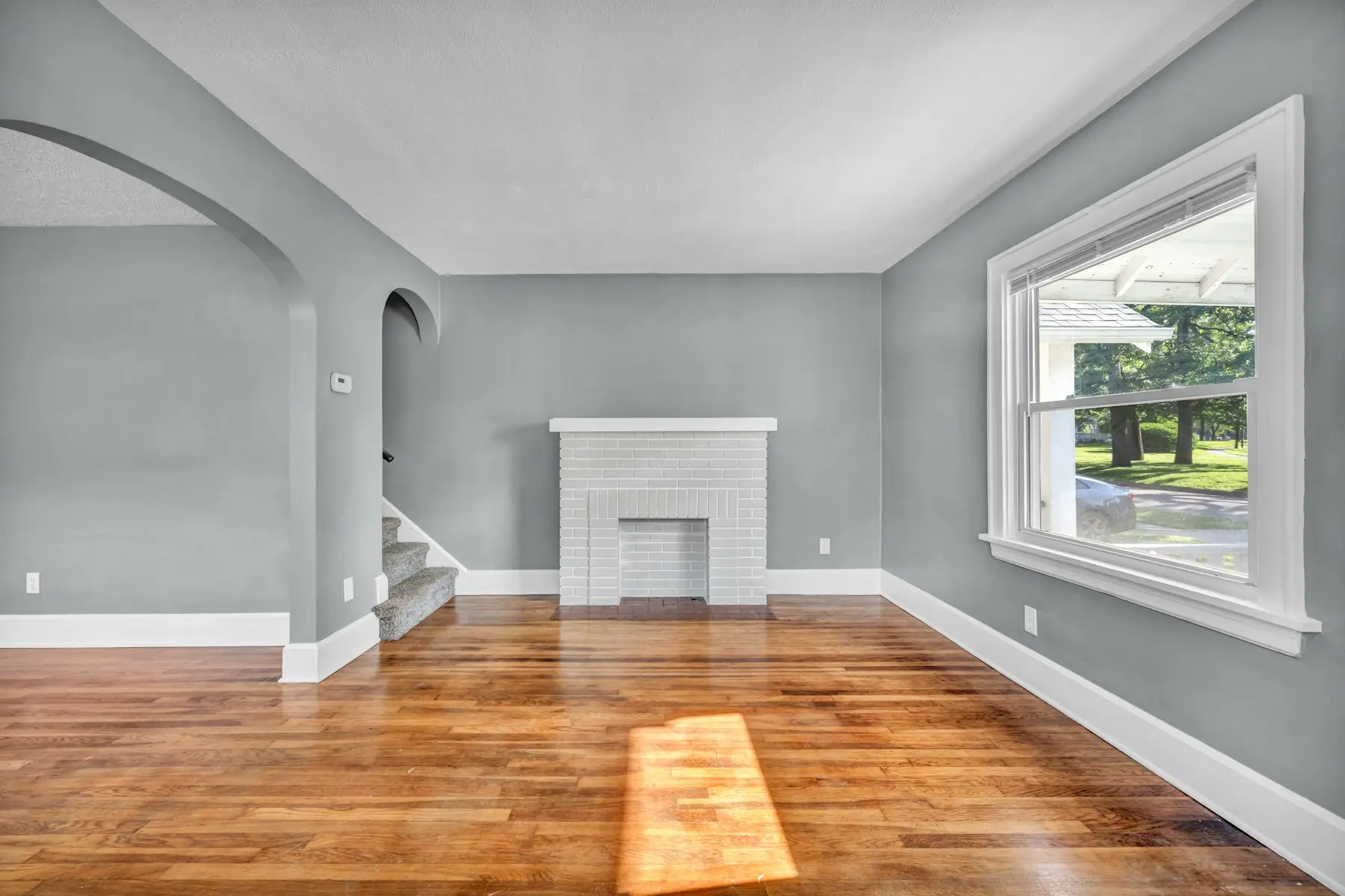 Painted brick fireplace and refinished hardwood floor
