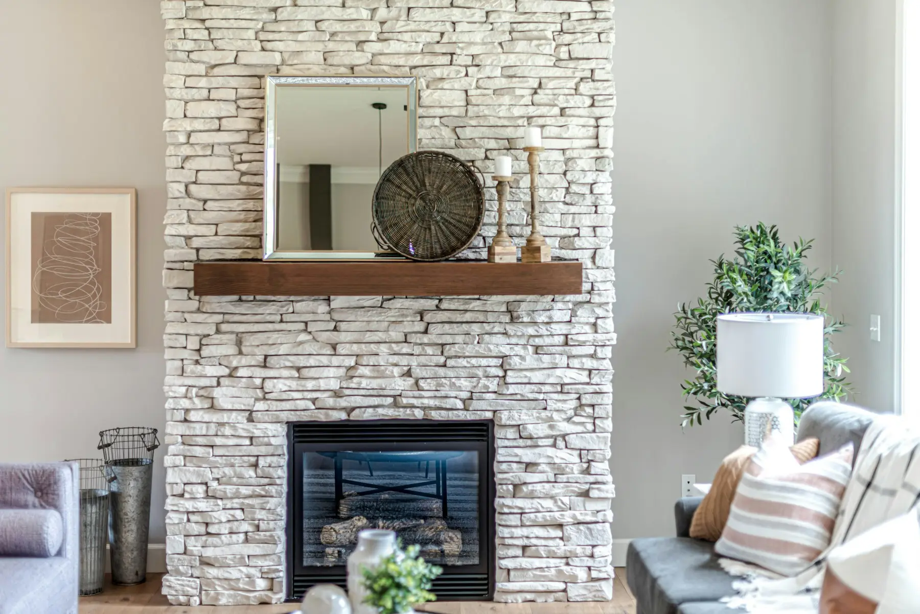 Stacked stone fireplace with rustic wood mantel